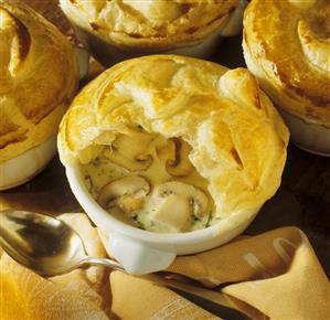 Mushroom soup with button mushrooms under puff pastry