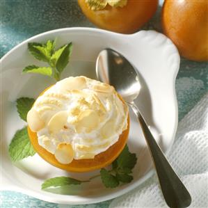 A halved sharon fruit with almond meringue topping