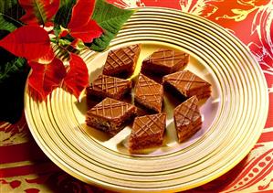 Chocolate diamonds on gold plate; flower