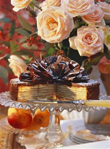 Tree cake gateau decorated with chocolate fans, a piece cut