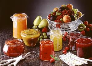 Several jams and preserves and fresh fruit on scales