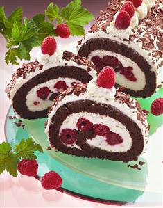 Chocolate sponge roulade filled with cream & raspberries