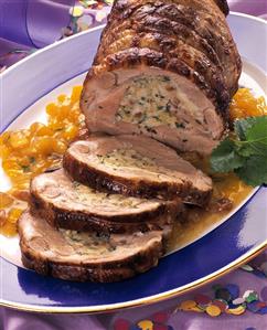 Roast pork roll with bread stuffing on mango chutney