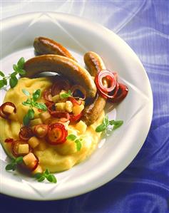 Fried sausages & mashed potato with apples & red onions