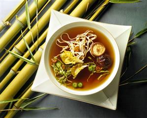 Miso soup with vegetables, mushrooms & noodles in bowl