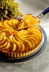 Peach tart, a piece cut, one piece on cake slice