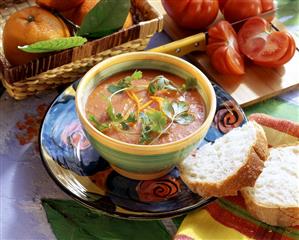 Tomato & orange soup garnished with parsley in small bowl