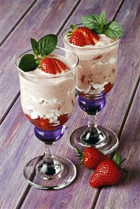 Two strawberry and meringue layered sundaes