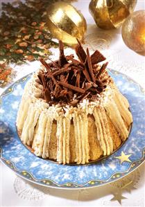 Mocha charlotte with cream & chocolate curls on Christmas plate