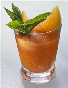 Papaya & pineapple drink, garnished with papaya slices & mint