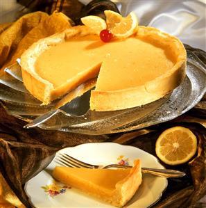 Lemon tart, a piece cut and one piece on plate