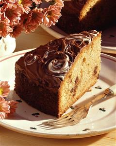 Piece of chocolate gateau (sponge, chocolate flakes & icing)