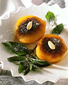 Caramelised apricots, decorated with almonds & mint sprig