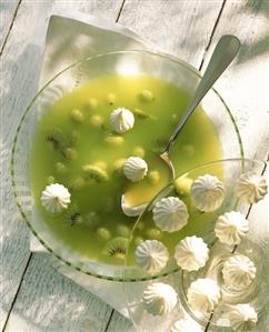 Cold gooseberry & kiwi soup with meringues in glass plate