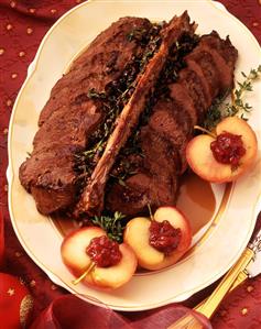 Saddle of venison & apples with cranberries on oval platter