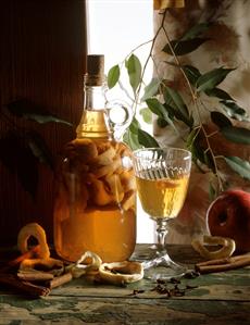 Home-made apple liqueur in glass and carafe