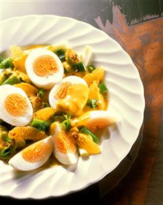 Boiled eggs with orange and spring onion ragout