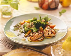 Lemon chicken breasts with vegetables on plate