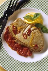 Tuna steak with tomato & orange sauce on plate