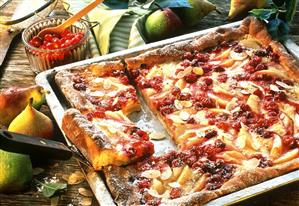 Pear and cranberry cake, on baking tray, pieces cut