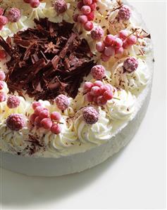 Raspberry ice cream cake with berries and chocolate curls