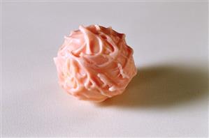 A pink chocolate truffle