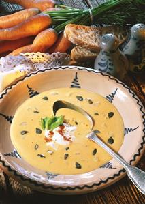 Cream of potato soup with pumpkin seeds in deep plate