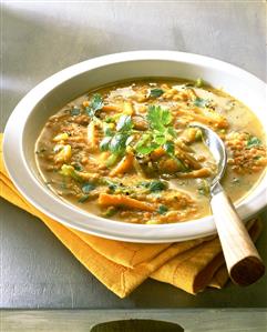 Red lentil soup with curry in deep plate