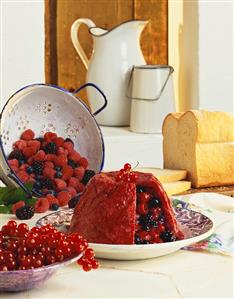 Turned-out summer pudding, decoration: fresh berries, bread