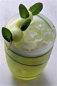 Melon juice in a glass with ice cubes