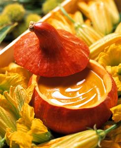 Pumpkin soup in hollowed-out pumpkin with lid