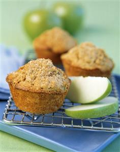 Apple muffins on a cake rake with apple wedges