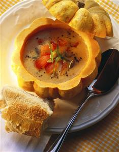 Pumpkin seed soup with tomatoes in hollowed-out pumpkin