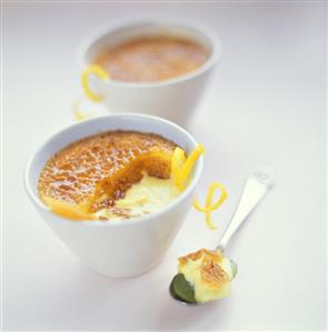 Crème brulee with lemon zest in a bowl and on a spoon