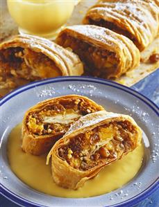 Peach and raisin strudel with custard