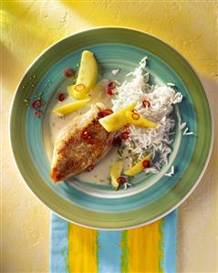 Fried chicken breast with rice and mango wedges