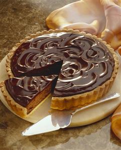 Chocolate nut tart, a piece cut