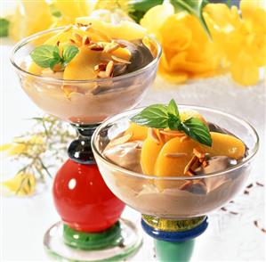 Espresso mousse with peach segments in bowl