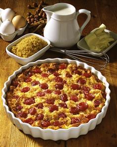 Cherry bread pudding in dish, ingredients behind