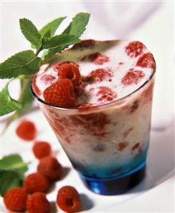 Milk shake with raspberries in a glass (2)