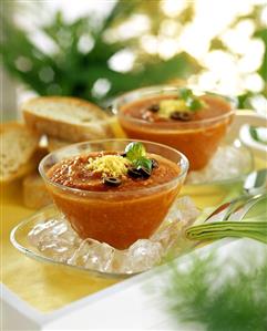 Gazpacho in bowls with olive rings & grated cheese