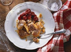 Sour cream and nut pancake with cherries on plate (2)