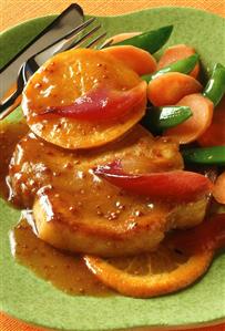 Pork steak with orange & mustard sauce & orange slices