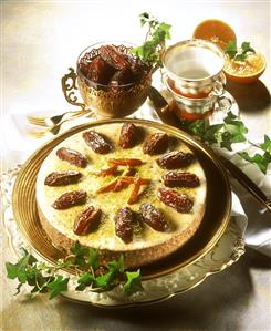 Carrot & date cake on cake plate garnished with dates