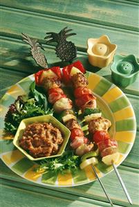 Two chicken and vegetables kebabs with pineapples & dip