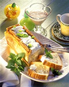 Apple pie with cinnamon sauce, a piece cut, on cake plate