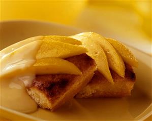 Mango cake with fresh mango wedges & custard