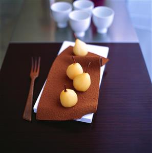 Poached pears on chocolate leaf