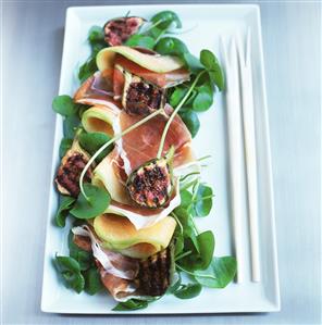 Melon with ham and grilled figs on watercress