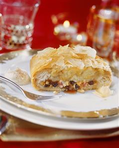 A piece of marzipan apple strudel on festive plate